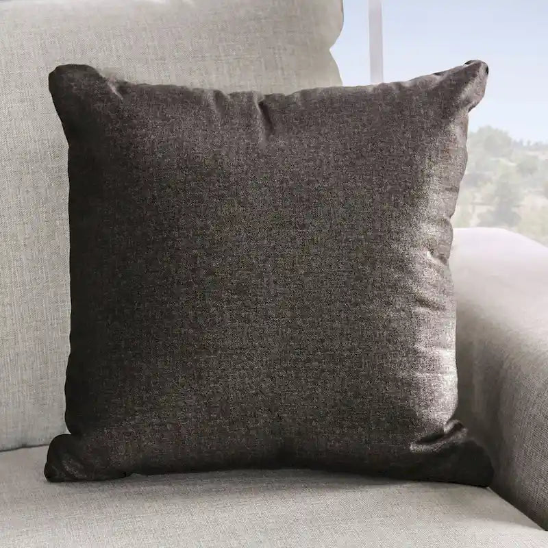 A light gray fabric upholstered sofa with a blue-toned transition style, adorned with rivets and featuring cushions.