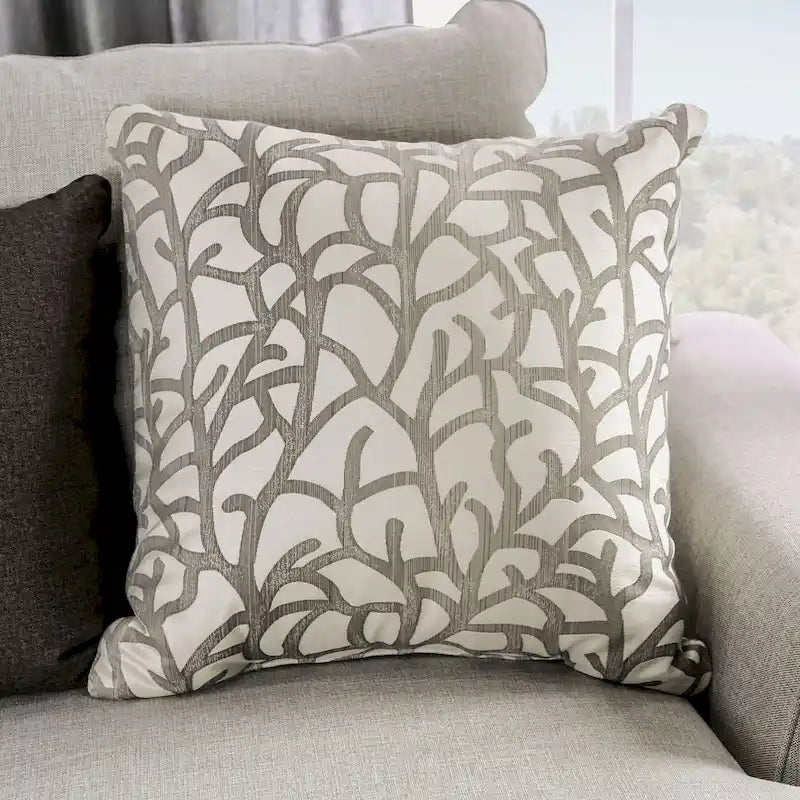 A light gray fabric upholstered sofa with a blue-toned transition style, adorned with rivets and featuring cushions.